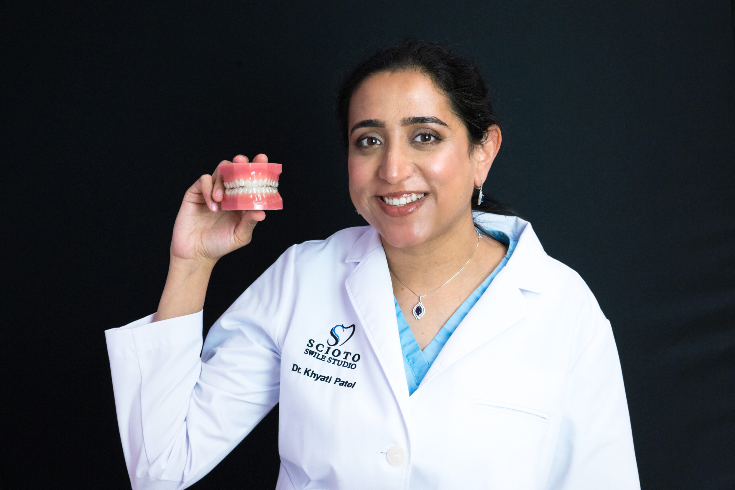 Dr. Patel holding the denture