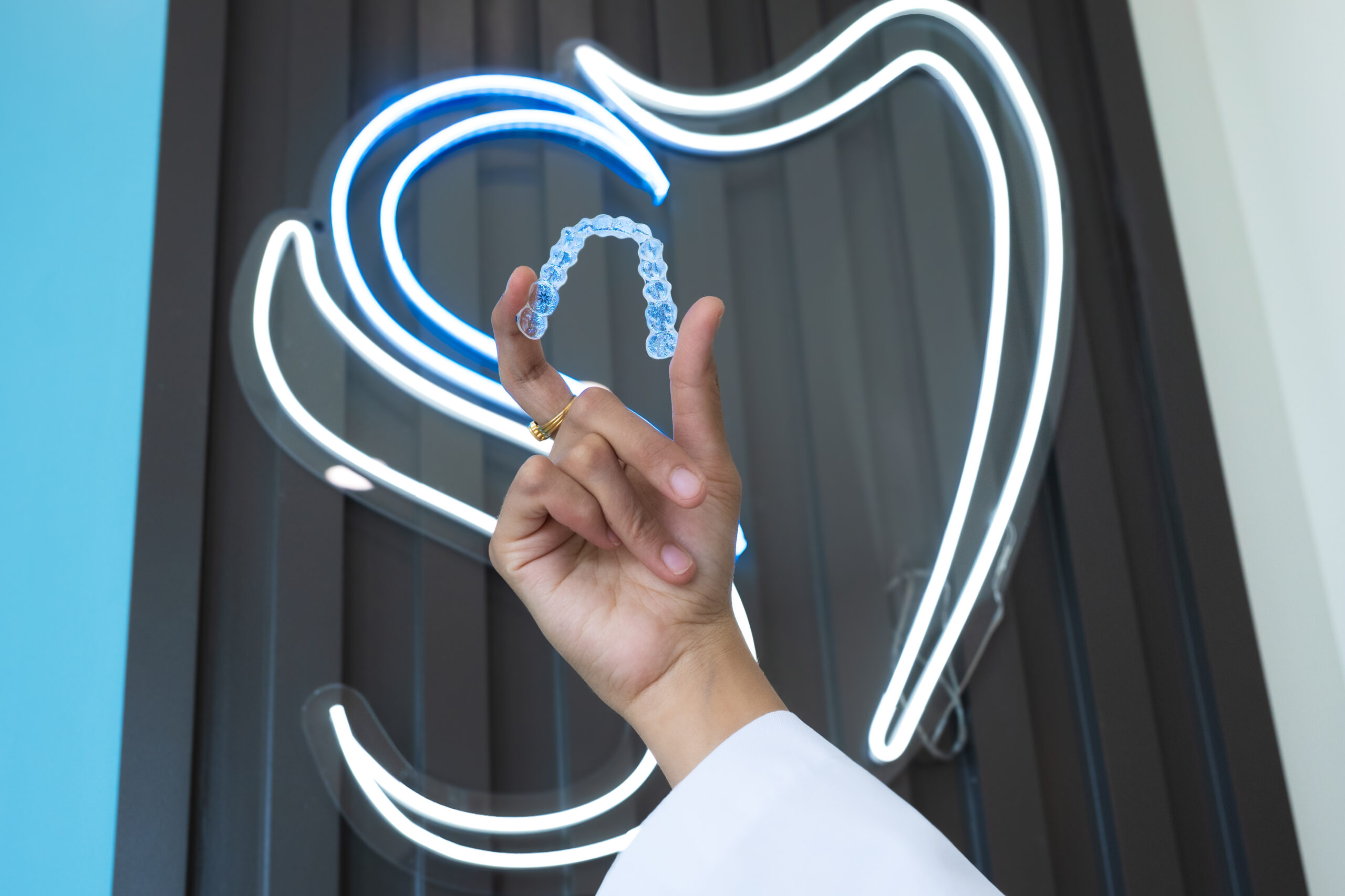 Dr. Patel holding Clear Braces