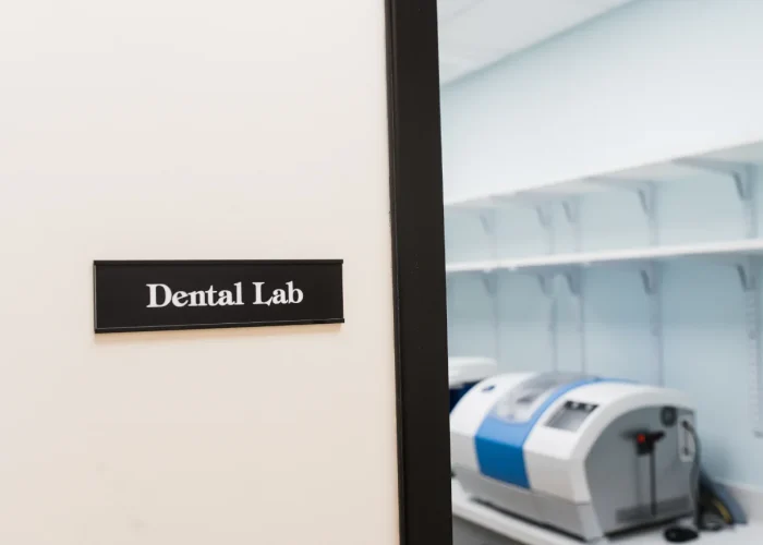Entrance to the Dental Lab at Scioto Smile Studio with labeled glass door and built-in cabinetry visible inside
