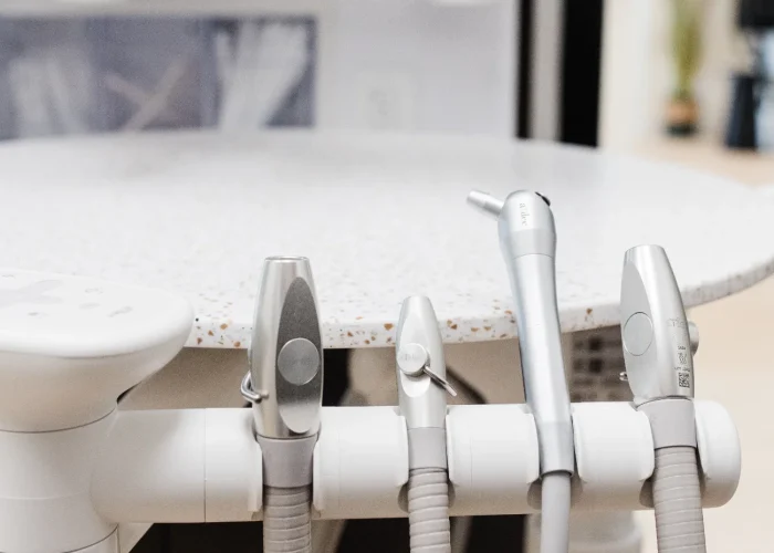 Close-up of dental instruments and control panel attached to a treatment chair at Scioto Smile Studio